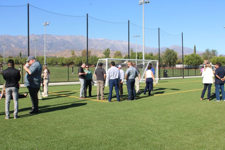 Guests on the new artificial turf field at the Beaumont Sports Park opening