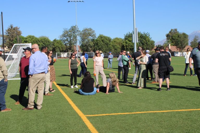 Attendees gathered at midfield for the Beaumont Sports Park ribbon cutting